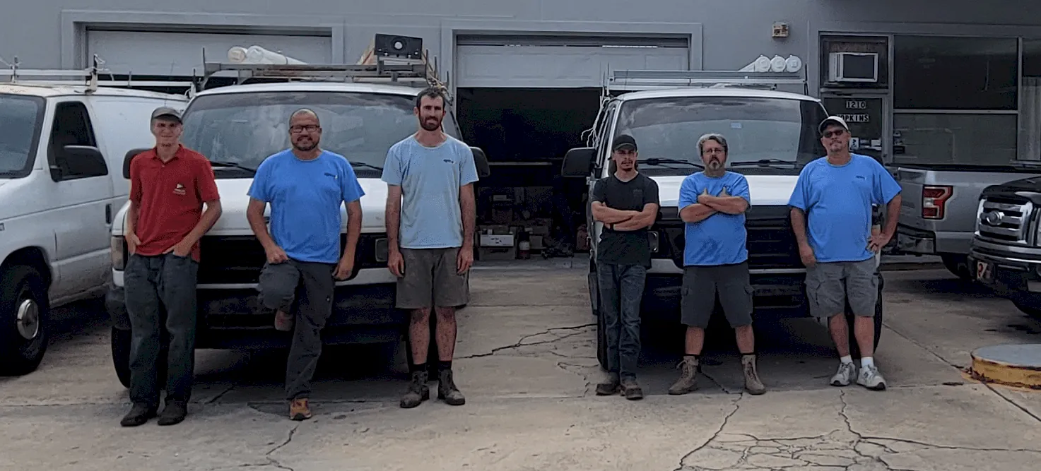 Advent Electric team in front of service vehicles